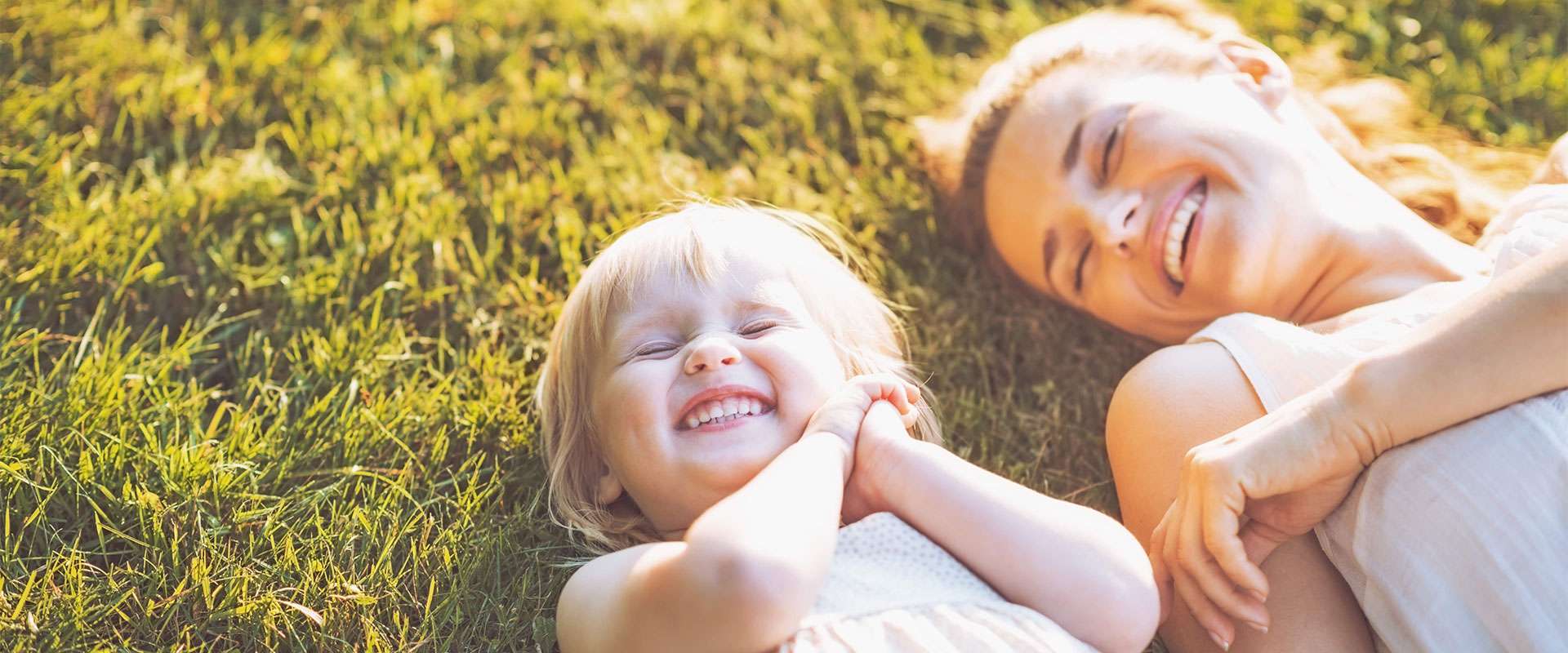Mom and toddler laughing after a great dental visit at Canton Childers's Dentistry