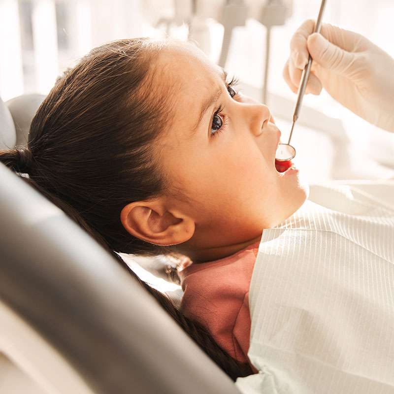 Girl undergoing pediatric dental exam at Canton Children's Dentistry